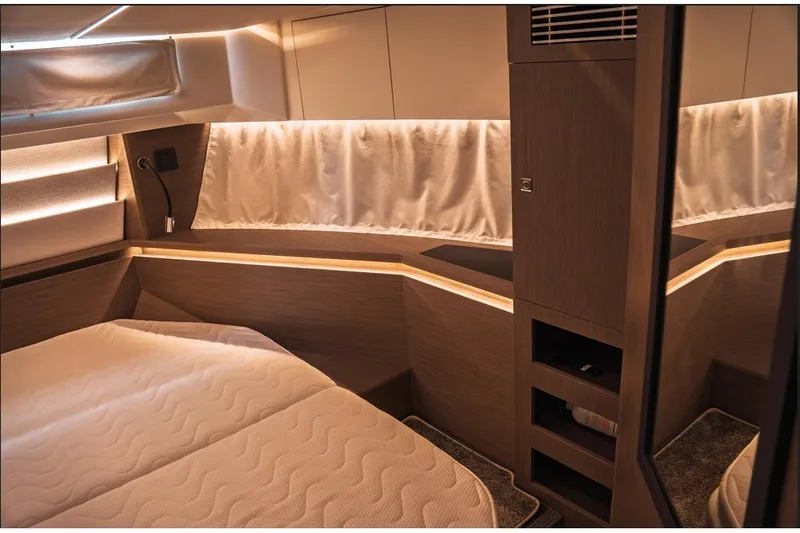Slide: The Image of Luxurious interior cabin of 2025 Jeanneau NC 1295 Coupe with ambient lighting. - 27