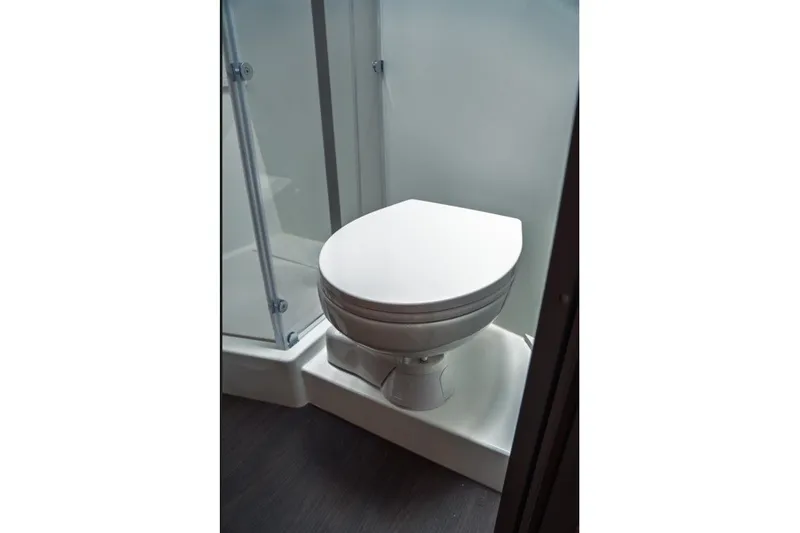 Slide: The Image of 2025 Jeanneau NC 1295 Coupe bathroom with modern toilet and shower enclosure. - 36