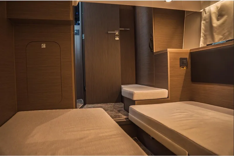 Slide: The Image of Interior cabin of 2025 Jeanneau NC 1295 Coupe, featuring modern wood finishes and cozy seating. - 42