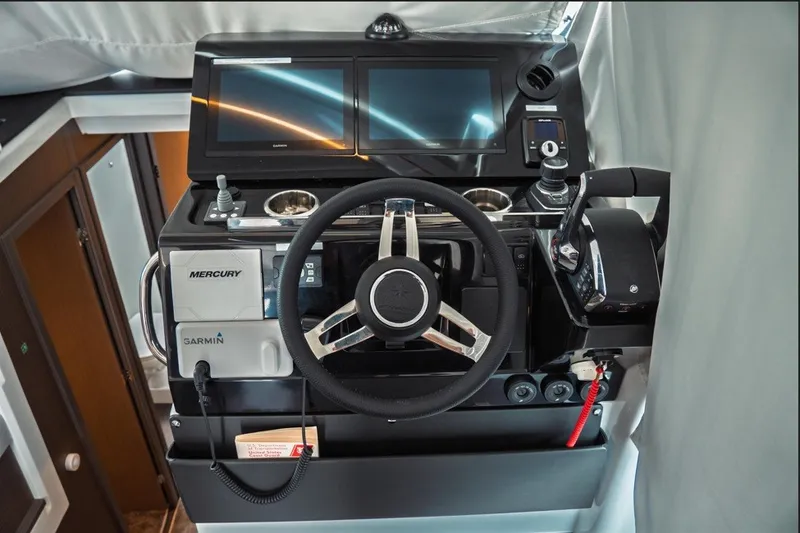 Slide: The Image of 2025 Jeanneau NC 1295 Coupe helm with Mercury and Garmin controls. - 16