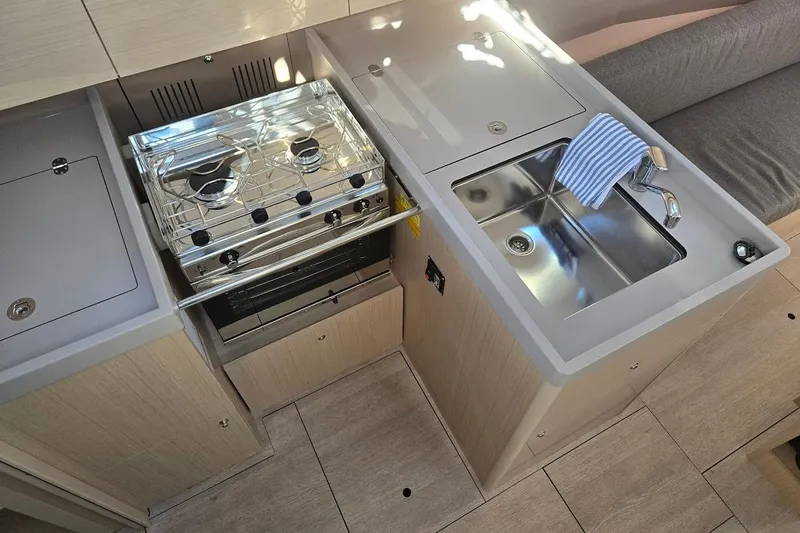 Slide: The Image of Modern kitchen area in 2023 Beneteau Oceanis 38.1 yacht with stove and sink. - 43