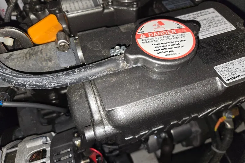 Slide: The Image of Engine compartment of a 2023 Beneteau Oceanis 38.1 sailboat, featuring a Yanmar engine. - 86