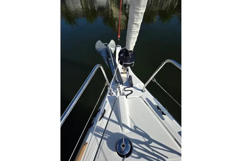 Slide: The Image of Bow of 2023 Beneteau Oceanis 38.1 sailboat with anchor and railing. - 76