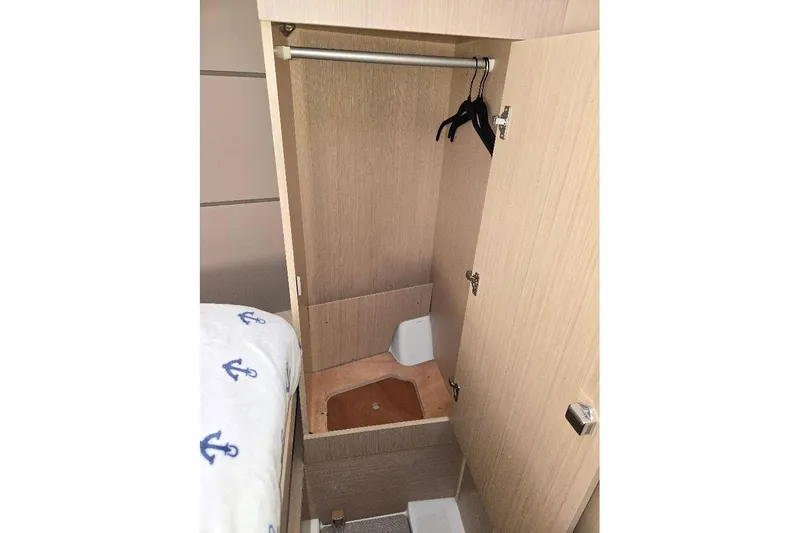 Slide: The Image of 2023 Beneteau Oceanis 38.1 interior closet with hangers and wooden finish. - 53