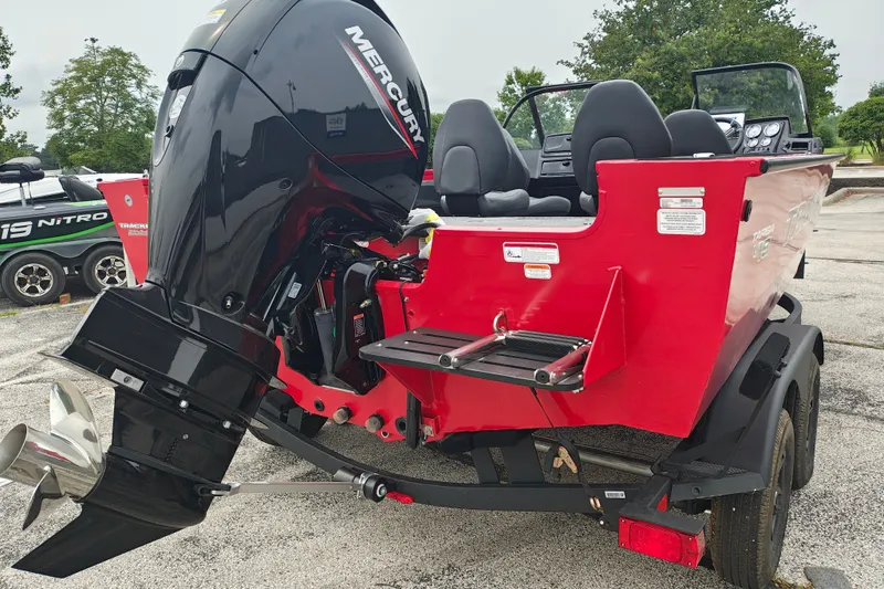 Slide: The Image of 2026 Tracker Targa V-19 WT boat with Mercury outboard motor, parked on a trailer. - 22