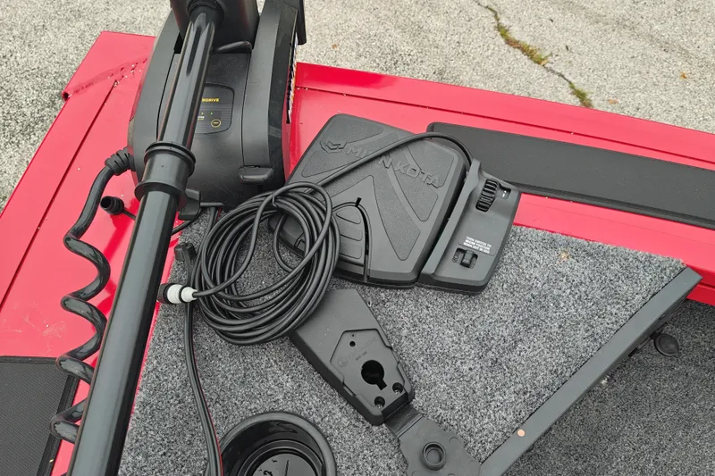 Slide: The Image of 2026 Tracker Targa V-19 WT boat with Minn Kota trolling motor and foot pedal on red deck. - 13