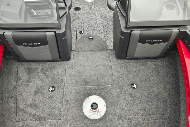 Slide: The Image of Interior view of 2026 Tracker Targa V-19 WT boat, featuring carpeted flooring and dual consoles. - 14
