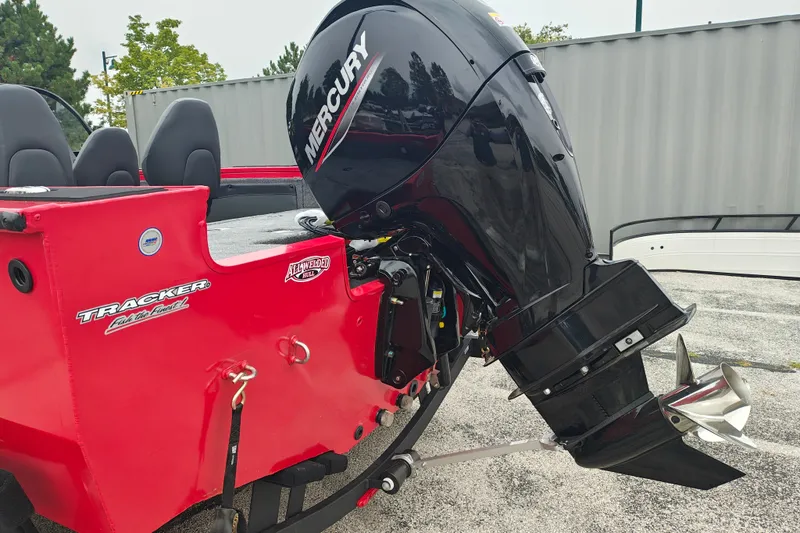 Slide: The Image of 2026 Tracker Targa V-19 WT boat with Mercury outboard motor, red exterior. - 20