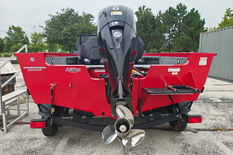 Slide: The Image of 2026 Tracker Targa V-19 WT boat, red exterior, rear view with outboard motor. - 21