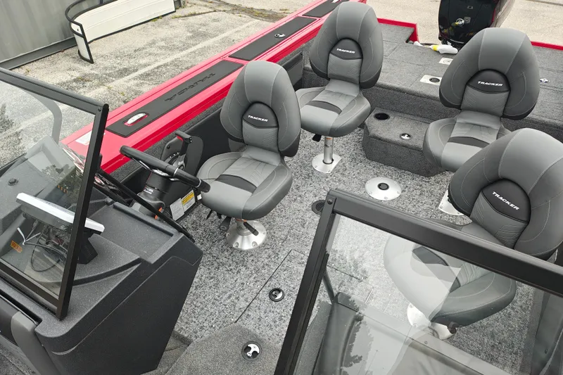 Slide: The Image of 2026 Tracker Targa V-19 WT boat interior with gray seating and steering console. - 17