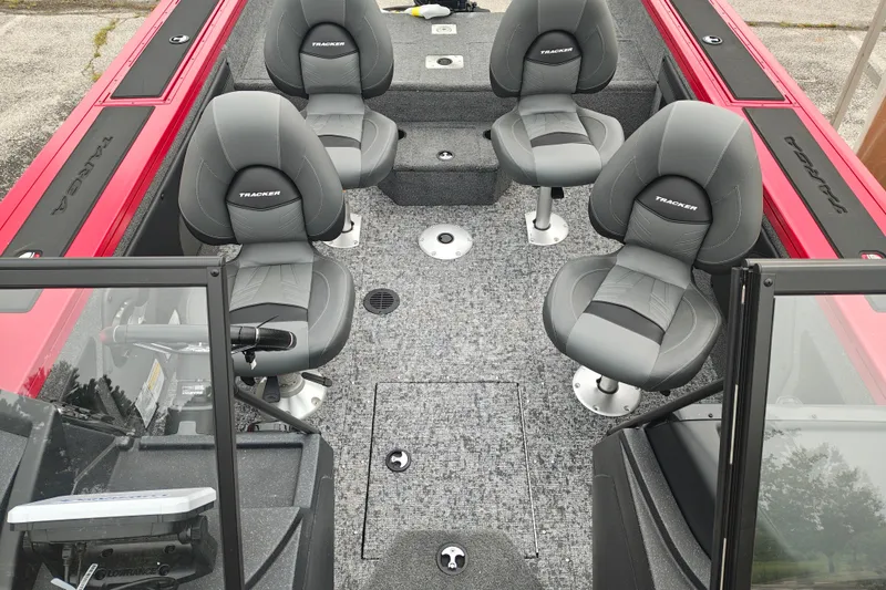 Slide: The Image of 2026 Tracker Targa V-19 WT boat interior with four gray seats and red accents. - 16