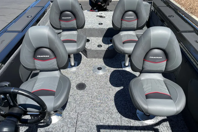 Slide: The Image of 2026 Tracker Targa V-19 Combo boat interior with four gray seats and steering wheel. - 21