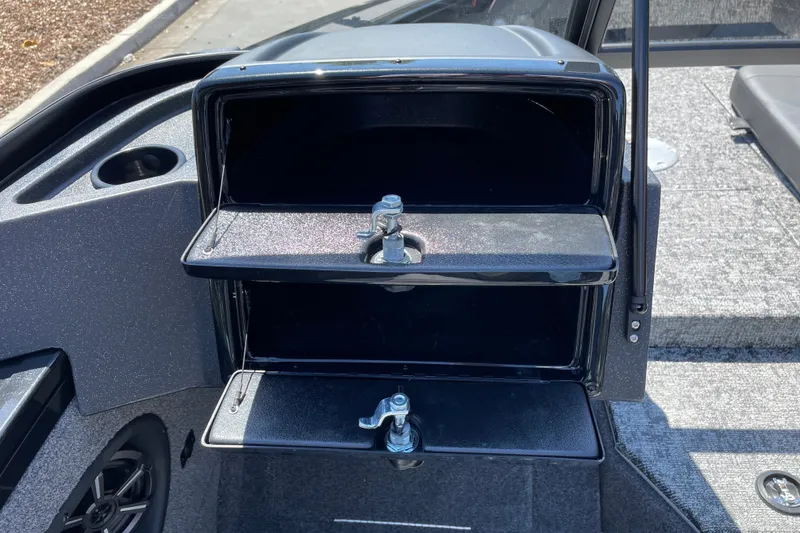 Slide: The Image of 2026 Tracker Targa V-19 Combo boat storage compartments with latches, gray interior. - 15