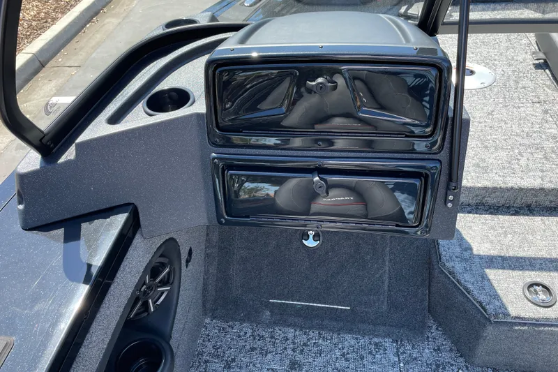 Slide: The Image of 2026 Tracker Targa V-19 Combo boat dashboard with storage compartments and cup holder. - 14