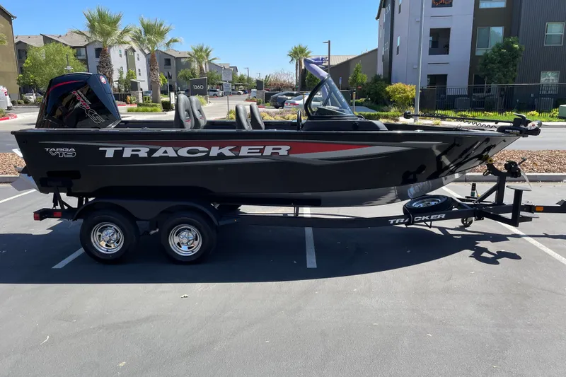 The Image of 2026 Tracker Targa V-19 Combo boat on trailer in urban parking lot. - 0