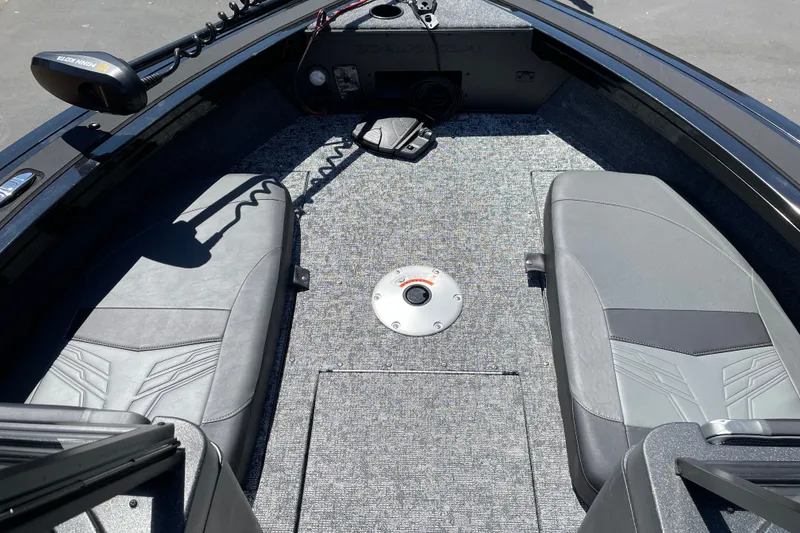 Slide: The Image of 2026 Tracker Targa V-19 Combo boat interior with gray seating and carpeted floor. - 17
