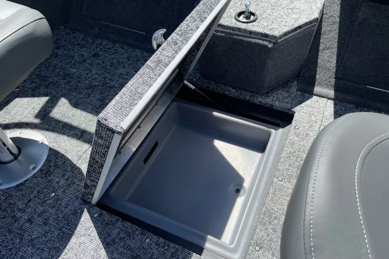 Slide: The Image of Open storage compartment in 2026 Tracker Targa V-19 Combo boat interior. - 18
