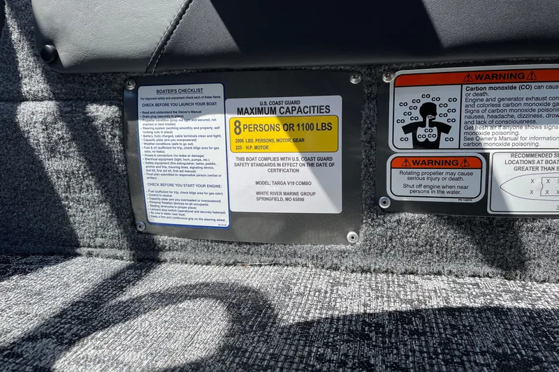 Slide: The Image of 2026 Tracker Targa V-19 Combo boat capacity and safety warning labels. - 20