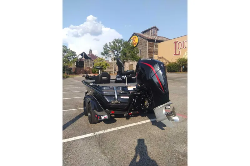 Slide: The Image of 2026 Nitro Z20 XL Pro boat in parking lot, rear view with motor. - 3
