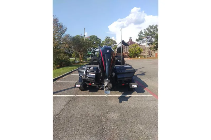 Slide: The Image of 2026 Nitro Z20 XL Pro boat parked in a sunny lot, rear view. - 2