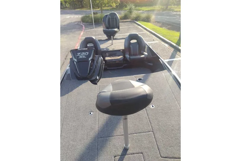 Slide: The Image of 2026 Nitro Z20 XL Pro boat interior with seating and deck in a parking lot. - 11