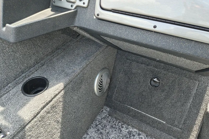 Slide: The Image of Interior of 2026 Tracker Pro Guide V-175 WT boat, featuring carpeted flooring and storage compartment. - 19