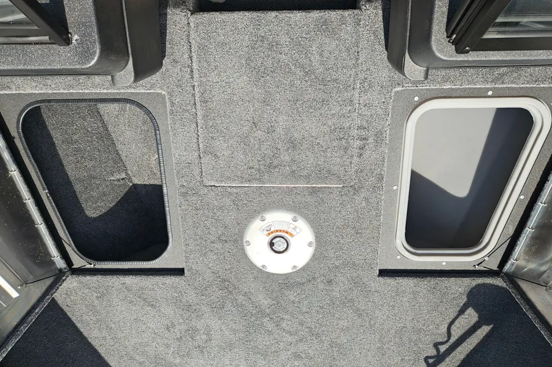 Slide: The Image of 2026 Tracker Pro Guide V-175 WT boat interior with carpeted flooring and storage compartments. - 24