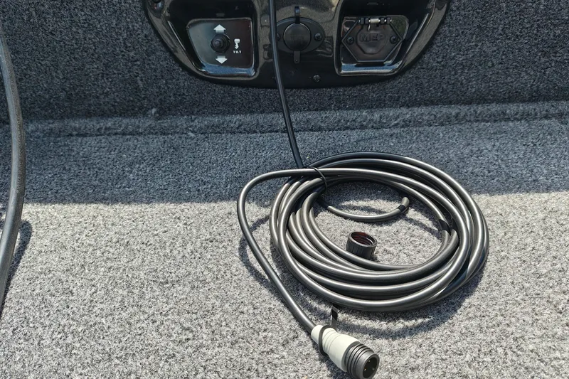 Slide: The Image of Coiled cable on 2026 Tracker Pro Guide V-175 WT boat's carpeted floor. - 28