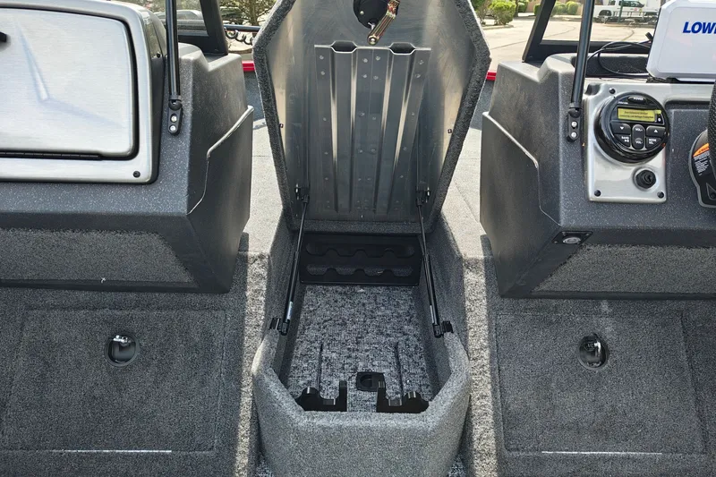Slide: The Image of 2026 Tracker Pro Guide V-175 WT boat interior with open storage compartment and control panel. - 21