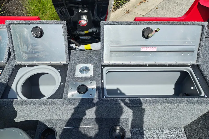 Slide: The Image of 2026 Tracker Pro Guide V-175 WT boat interior with open storage compartments and pump-out feature. - 36