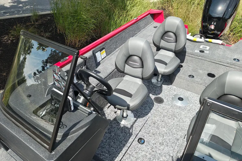 Slide: The Image of 2026 Tracker Pro Guide V-175 WT boat interior with gray seating and steering console. - 32