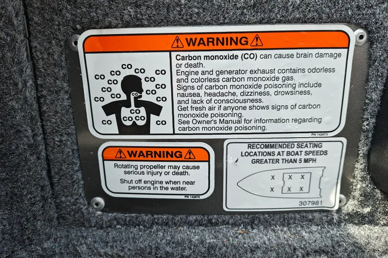 Slide: The Image of Warning labels on a 2026 Tracker Pro Guide V-175 WT boat, highlighting carbon monoxide risks. - 14