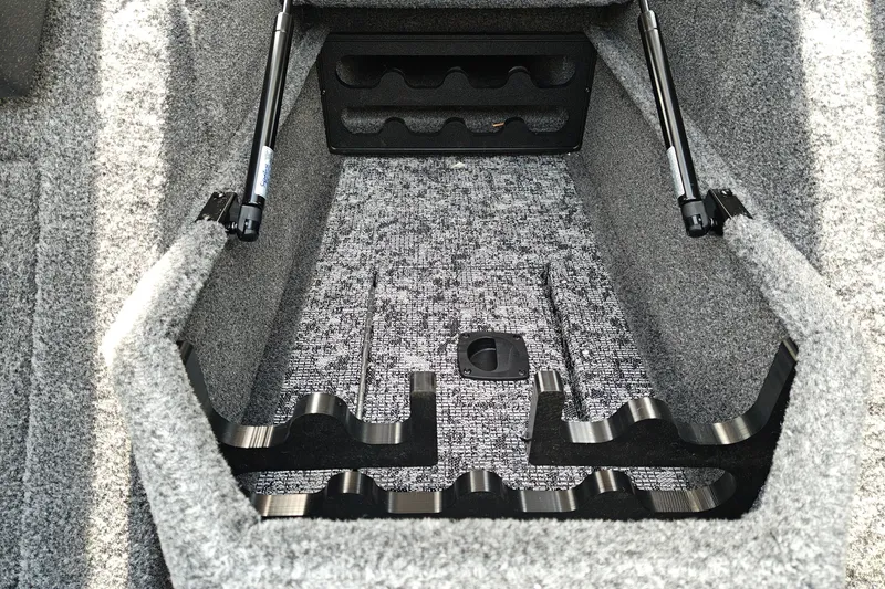 Slide: The Image of 2026 Tracker Pro Guide V-175 WT boat storage compartment with carpeted interior and hydraulic supports. - 22