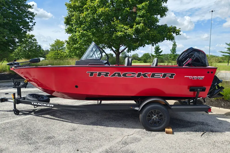 The Image of 2026 Tracker Pro Guide V-175 WT boat in vibrant red on a trailer, parked outdoors. - 1