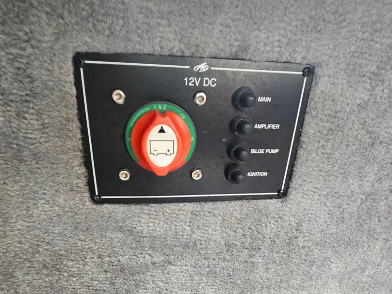Slide: The Image of 2012 Monterey 244 FS 12V DC control panel with switches for main, amplifier, bilge pump, ignition. - 26
