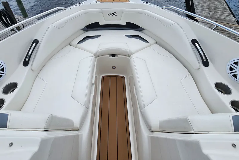 Slide: The Image of Interior of 2012 Monterey 244FS boat with white seating and wood flooring. - 19