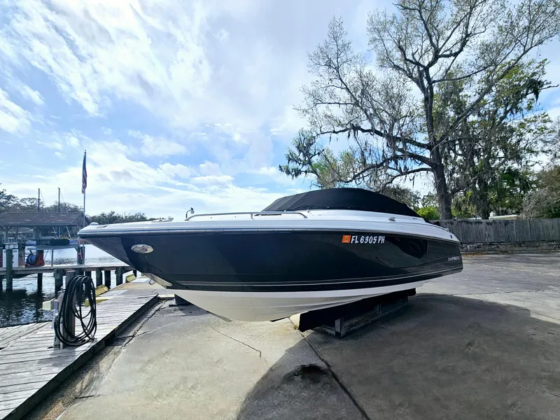 Slide: The Image of 2012 Monterey 244 FS boat on a dock, under a clear sky. - 24