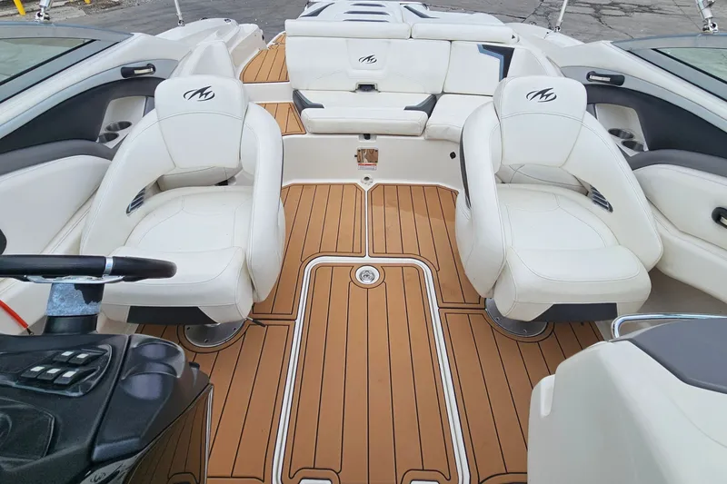 Slide: The Image of Interior of a 2012 Monterey 244FS boat with white seating and teak flooring. - 22