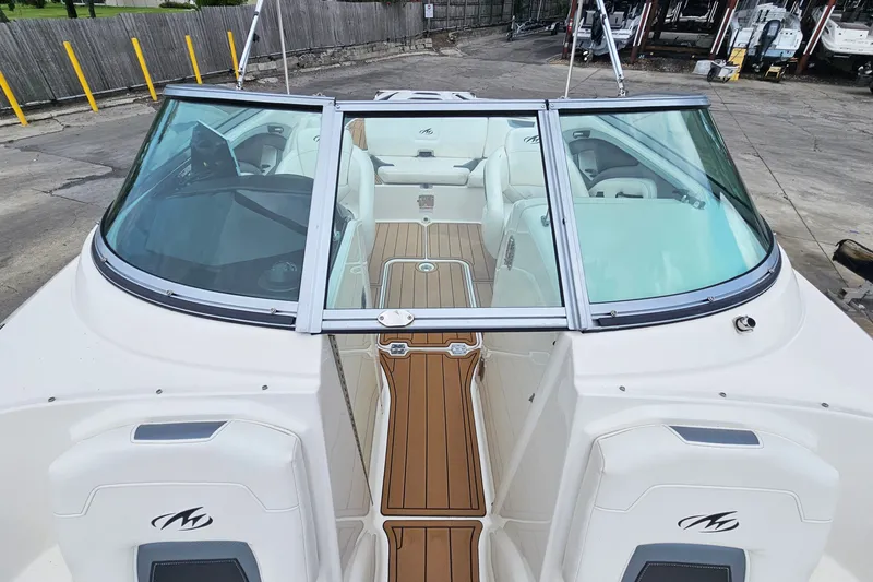 Slide: The Image of 2012 Monterey 244FS boat with sleek design and spacious interior at a marina. - 21