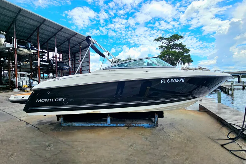 The Image of 2012 Monterey 244FS boat on dock, blue sky background, marina setting. - 5