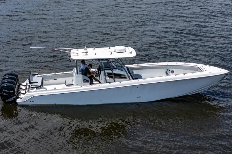 Slide: The Image of 2018 Nor-Tech 392 Super Fish boat on water, featuring multiple outboard engines. - 43