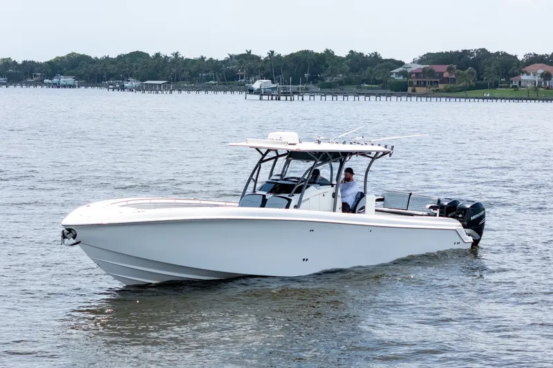 Slide: The Image of 2018 Nor-Tech 392 Super Fish boat cruising on calm waters near a scenic shoreline. - 39