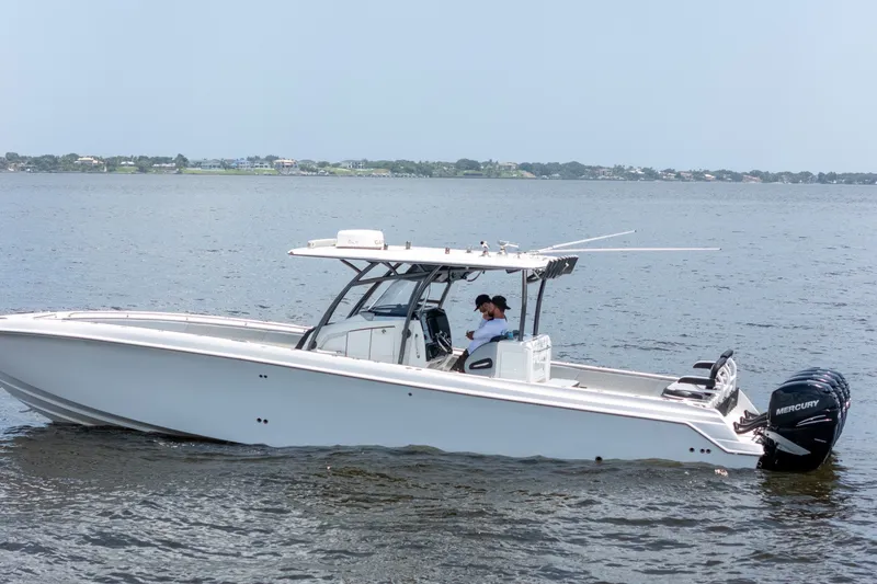 Slide: The Image of 2018 Nor-Tech 392 Super Fish boat on calm water with Mercury engines. - 35