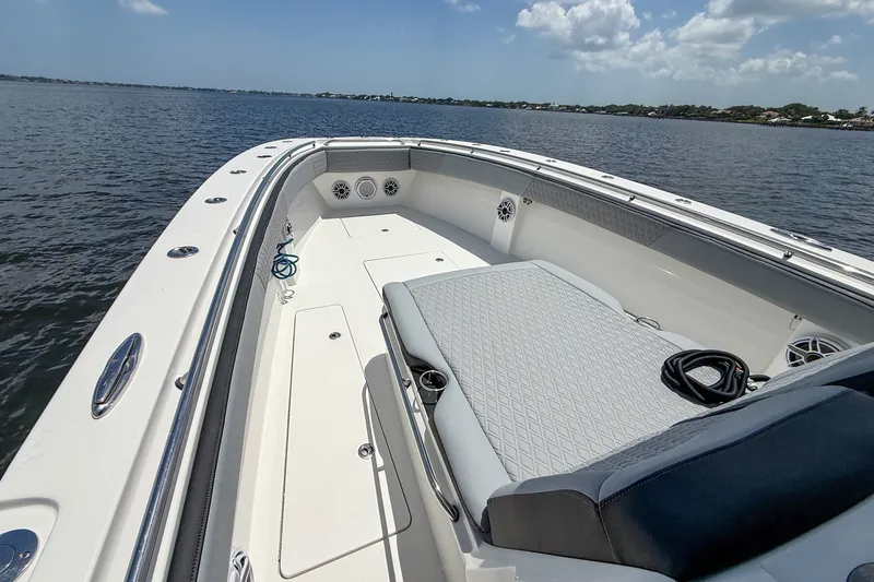 Slide: The Image of 2018 Nor-Tech 392 Super Fish boat on calm water, featuring spacious deck and seating. - 11