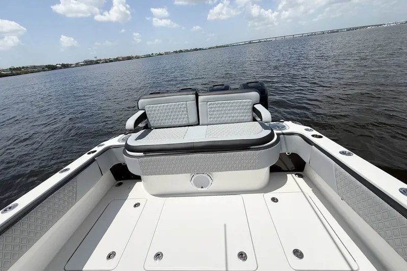 Slide: The Image of 2018 Nor-Tech 392 Super Fish boat interior with cushioned seating on calm water. - 4