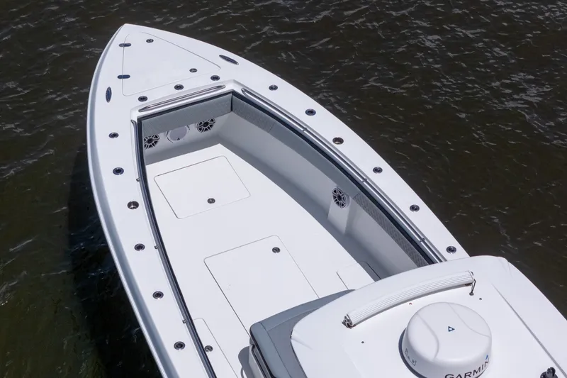 Slide: The Image of 2018 Nor-Tech 392 Super Fish boat deck on water, featuring sleek design and Garmin equipment. - 53