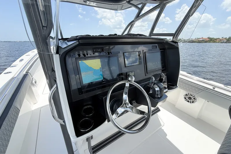 Slide: The Image of 2018 Nor-Tech 392 Super Fish boat cockpit with advanced navigation system and steering wheel. - 23