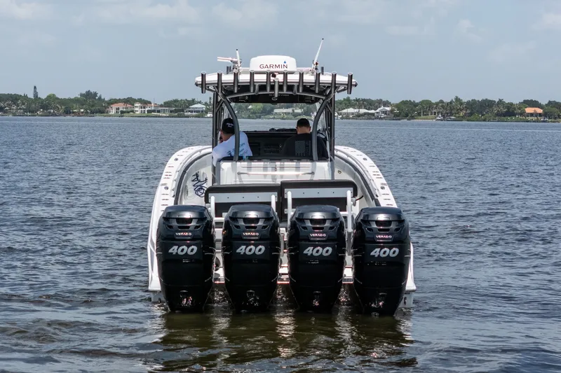 Slide: The Image of 2018 Nor-Tech 392 Super Fish boat with four powerful outboard engines on the water. - 1