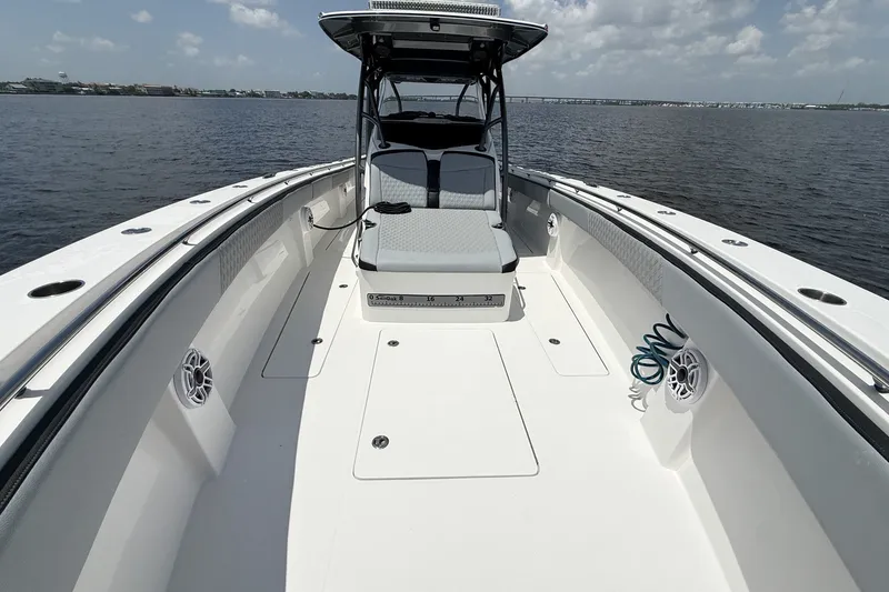 Slide: The Image of 2018 Nor-Tech 392 Super Fish boat on calm water, showcasing spacious deck and seating. - 12