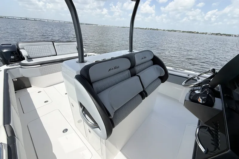 Slide: The Image of 2018 Nor-Tech 392 Super Fish boat interior with seating and steering wheel on open water. - 8